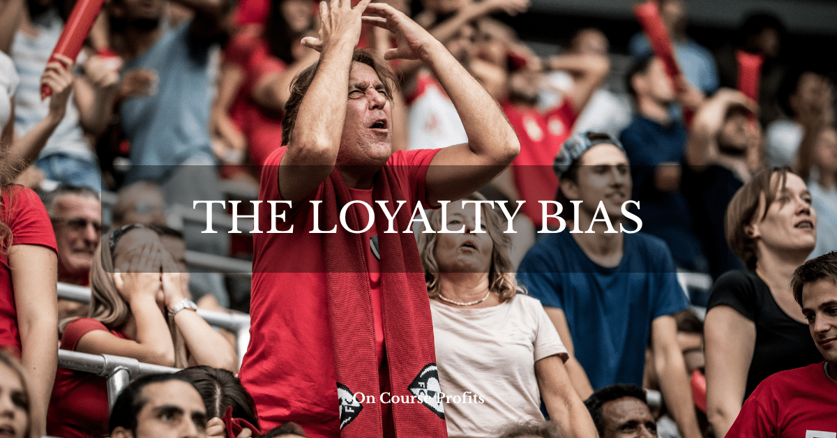 Image shows a football fan in a red shirt with a pained expression as if his team have missed a goal.